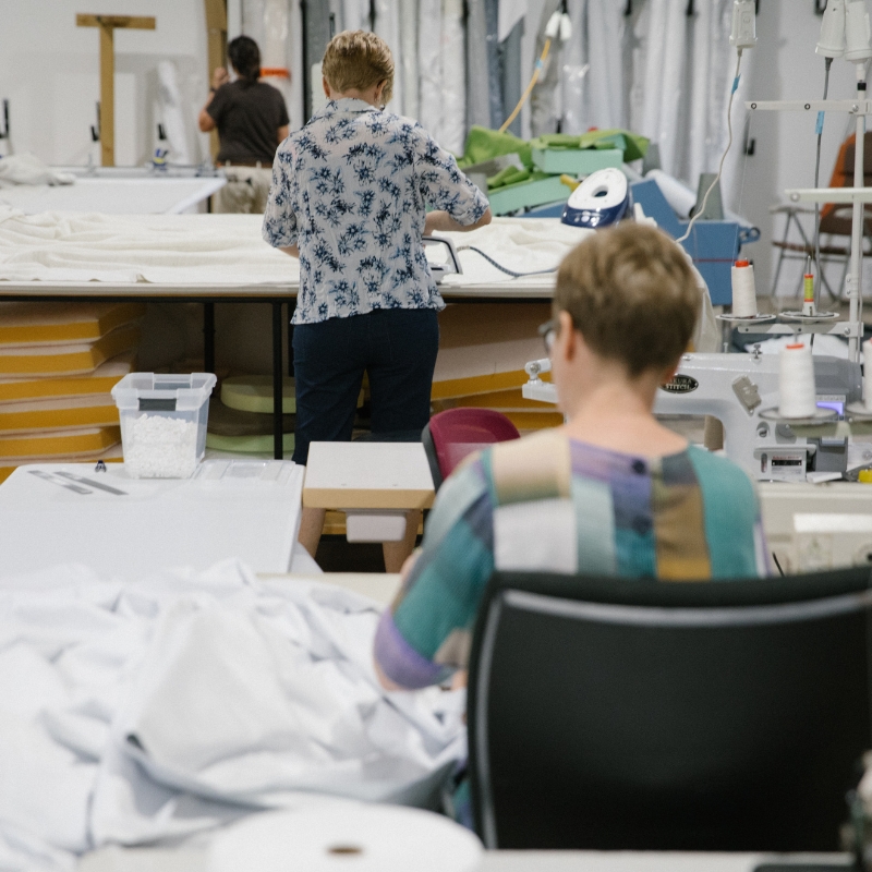 women sewing curtains