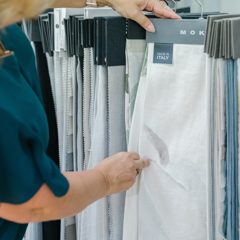 woman looking at curtain options
